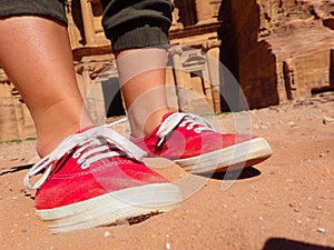 Red Sneakers in front of Facade at Petra in Jordan