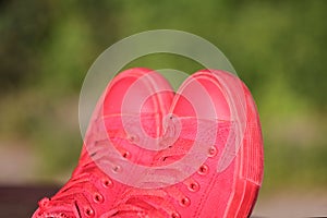 Red sneakers on green background