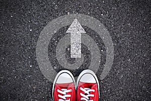 Red sneakers on road background