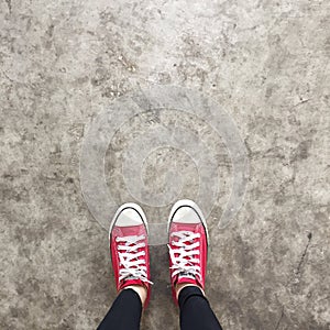 Red Sneakers Shoes Walking On Dirty Concrete Top View , Canvas Shoes Walking On Concrete