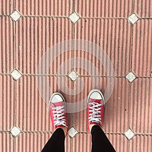 Red Sneakers Shoes Walking On Dirty Concrete Top View , Canvas Shoes Walking On Concrete