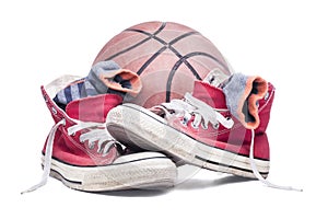 Red sneakers with stripped socks and basket ball.