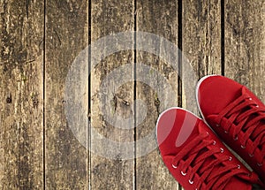 Red sneakers on wooden deck