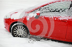 Red snow covered car
