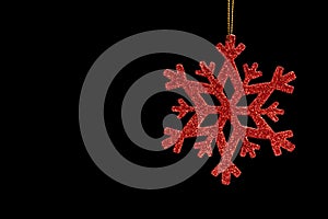 Red snow flake on a black background