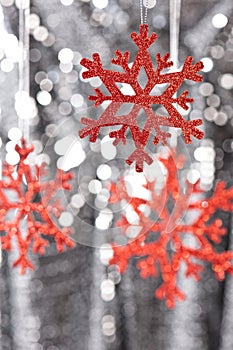 Red snow flake on a silver glitter background