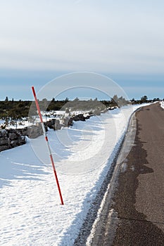 Red snow stake by roadside