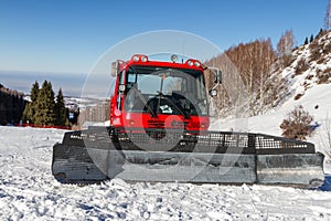 Red snowcat in mountains of Kazakhstan in ski resort