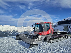 Red snowcat on the mountains