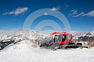Red snowcat ratrack mountain panorama