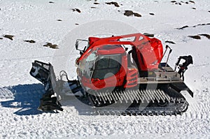 Red Snowcat travels on snow