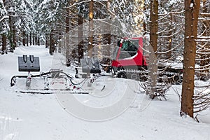 red snowmobile in the winter snowy forest