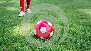 Red soccer ball on a green field