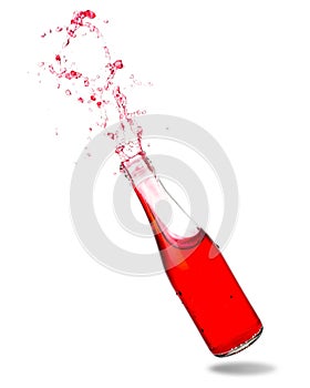 Red soda in bottle splashing