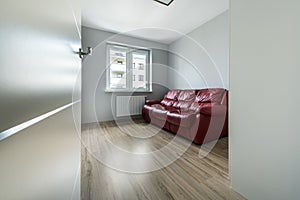 Red sofa in empty room