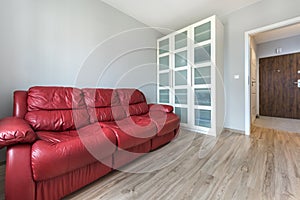Red sofa in empty room