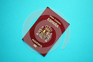 Red Spanish passport of European Union on blue background close up photo