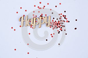 Red sparkles scattered on a white background with the word happy in english