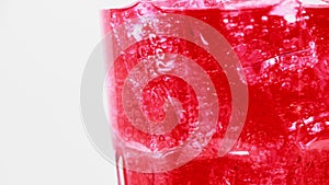 Red sparkling water with Ice in glass.