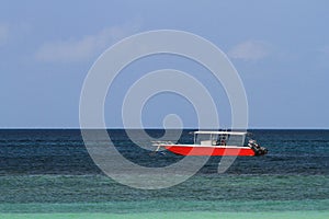 Red speed boat parked along the coast