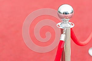 Red sphere on stand in red setting, reflective surface, diffuse artificial lighting, interior space hinted photo