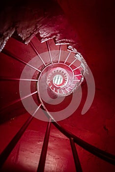 Red spiral staircase low angle vertical view