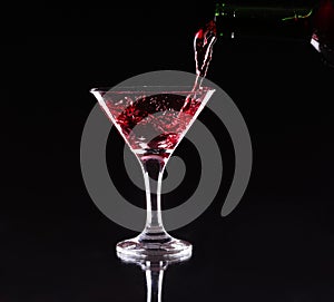 Red splashing cocktail on black