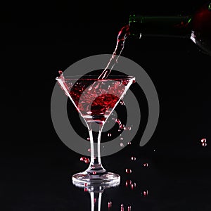 Red splashing cocktail on black