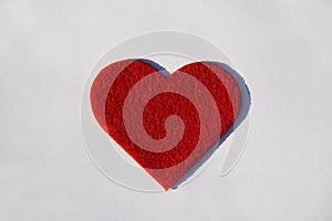 Red spongy heart on white paper background