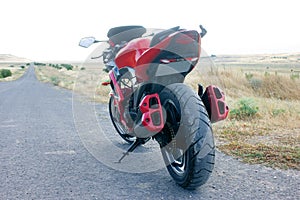 Red sport bike stands on the track