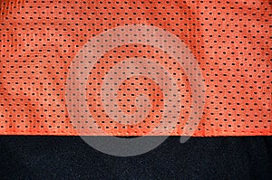 Red sport clothing fabric texture background. Top view of red cloth textile surface. Bright basketball shirt. Text Spac