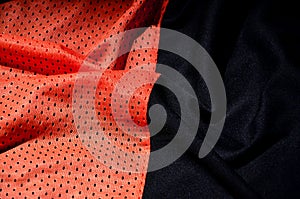 Red sport clothing fabric texture background. Top view of red cloth textile surface. Bright basketball shirt. Text Spac