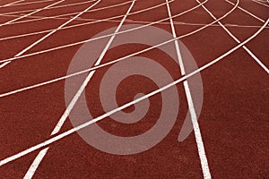 Red sport running tract with white line lane floor of outdoor stadium background