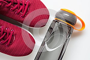 Red sport shoes and bottle of water. Active healthy lifestyle background concept. Fitness and wellness healthy living, dieting