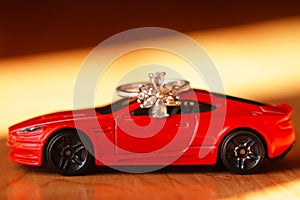 The red sports car bears a ring with a white crystal.