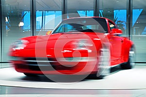 Red Sports Car on Rotating Platform