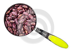 Red spotted pinto beans in measuring cup cutout