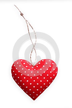 Red spotted sewed pillow heart isolated on white background, valentine