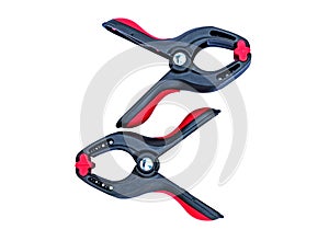 Red spring clamp on white