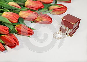 Red spring tulips with small box with pearls romantic present