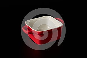 Red ceramic baking dish. Isolated on black background