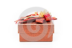 Red square gift box with golden bow on white background.