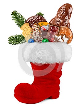Red st nicholas day boot filled with chocolate santa claus cookies gingerbread cinnamon stars orange and green fresh fir branches