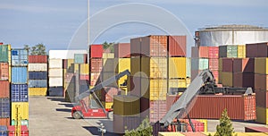 The red stacker stacks shipping containers at the port warehouse terminal