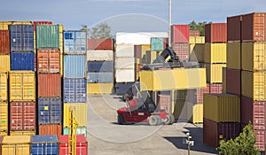 The red stacker stacks shipping containers at the port warehouse terminal