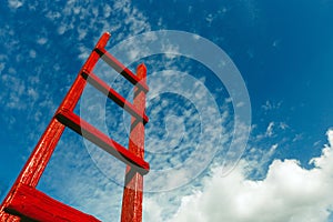 Red wooden staircase against the blue sky. Development Motivation Business Career Heaven Growth Concept