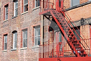 Red Stairs on a Fire Escape on the Side of an Old Building in New York City