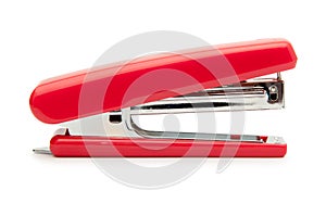 Red stapler on a white background.