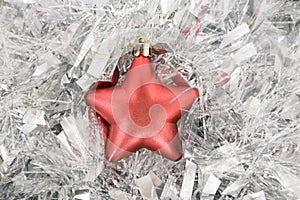 Red star, christmas decoration on silver tinsel