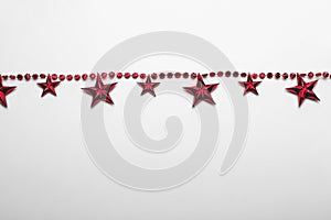 Red star garland on white backgroun. Flat lay.  Top view
